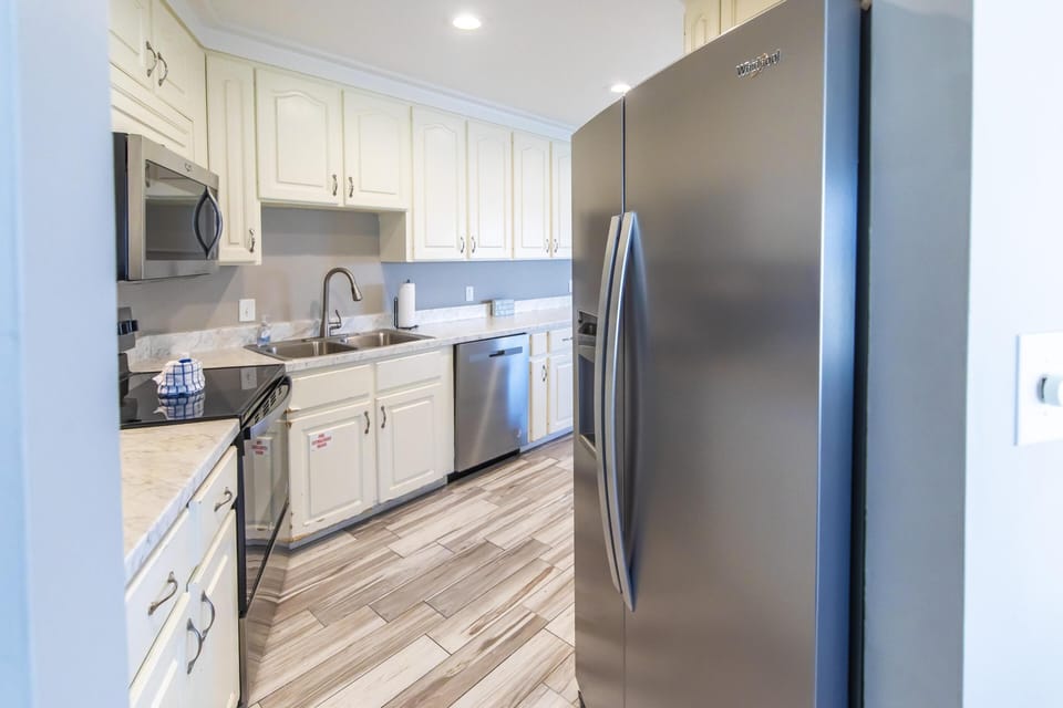 Bright, modern kitchen with stainless steel appliances and ample storage