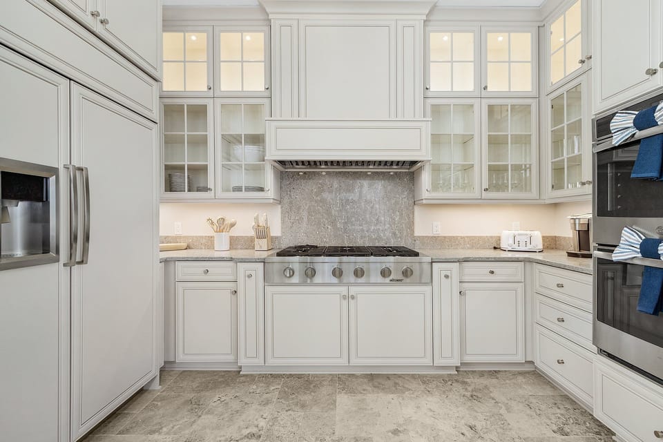 Featuring double ovens, dual dishwashers, a drawer microwave, a large refrigerator, a gas stove, and ample counter space, all fully stocked with cooking essentials