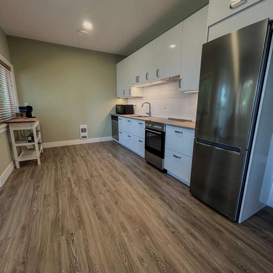 Fully equipped kitchen is spacious and bright.
