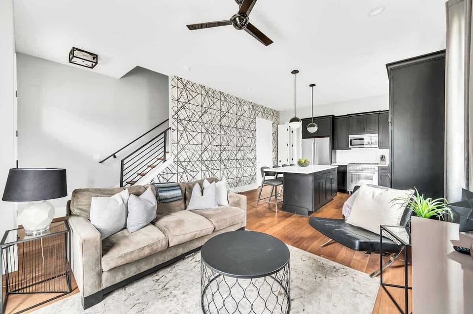 Enjoy the ample space and natural light in this living room, featuring a comfortable sofa bed for additional sleeping capacity and a stylish, welcoming design.

