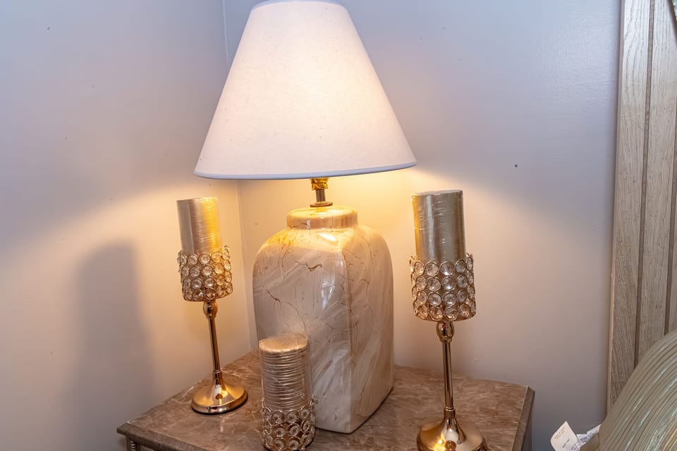 Queen Suite with French doors has night stand with lamp for more light.