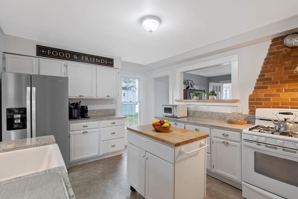 Featuring stainless steel appliances, granite countertops, and a charming farmhouse sink.