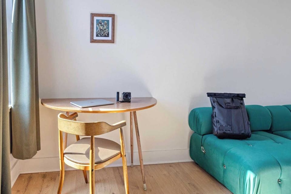 Work remotely in comfort at this chic vacation rental, featuring a cozy workspace bathed in natural light.