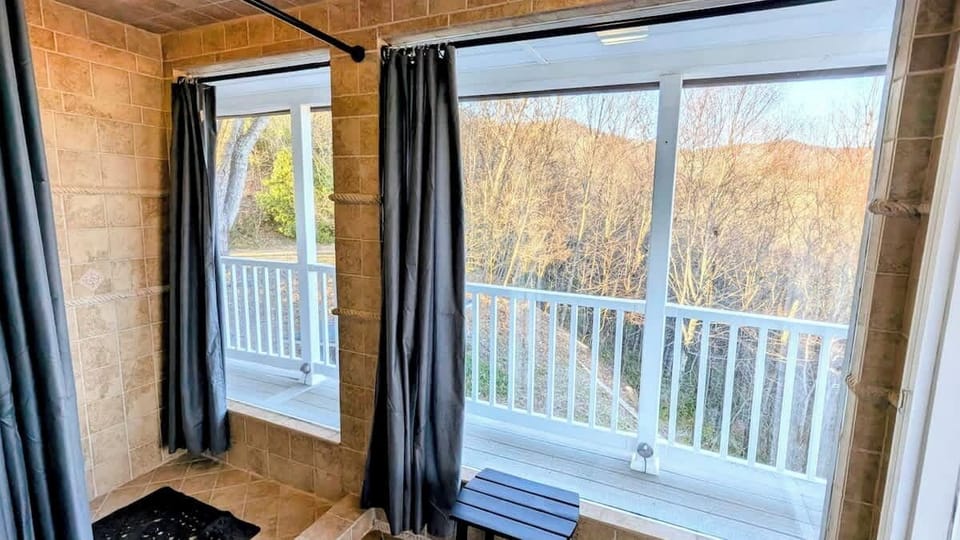 Master "Outdoor" shower!! Feels like you are outside with huge picture windows but it is enclosed for comfort. You can leave curtains open for "outdoor" feel or close them for privacy. Shower has multiple settings including jets and rain shower.