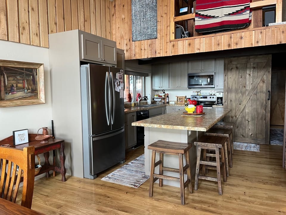 Full kitchen with large fridge, oven and range, microwave, and dishwasher!