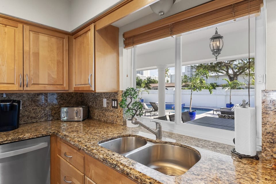Fully Equipped Kitchen featuring Premium Granite Surfaces and Beautiful Water View