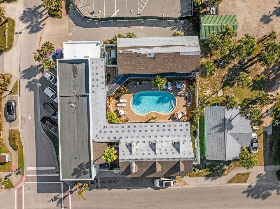 The complex features a private pool, ideal for cooling off after a day at the beach, and beautifully landscaped grounds that add to its inviting atmosphere.