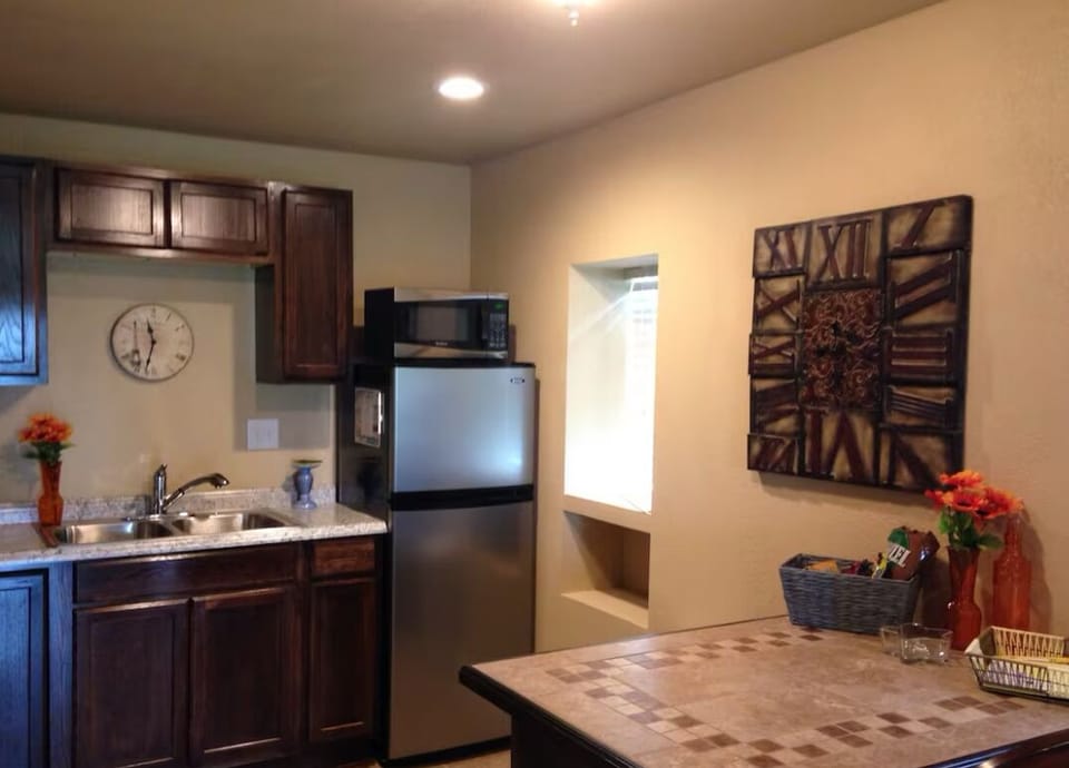 Full kitchen with medium size fridge, stove, oven and island with bar stools!