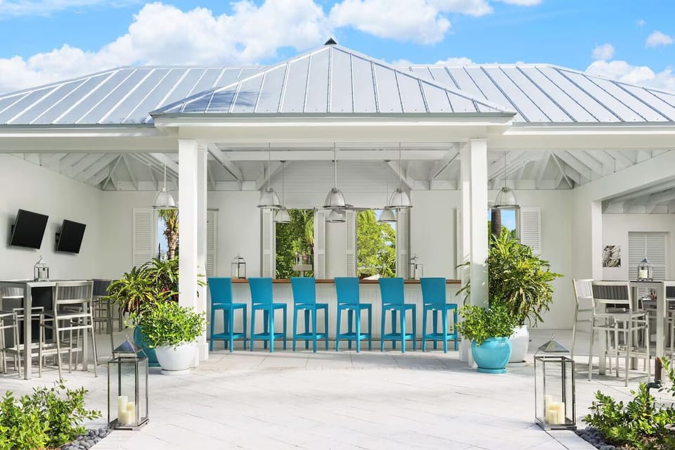 Sip breezy cocktails at the open-air bar under bright skies.