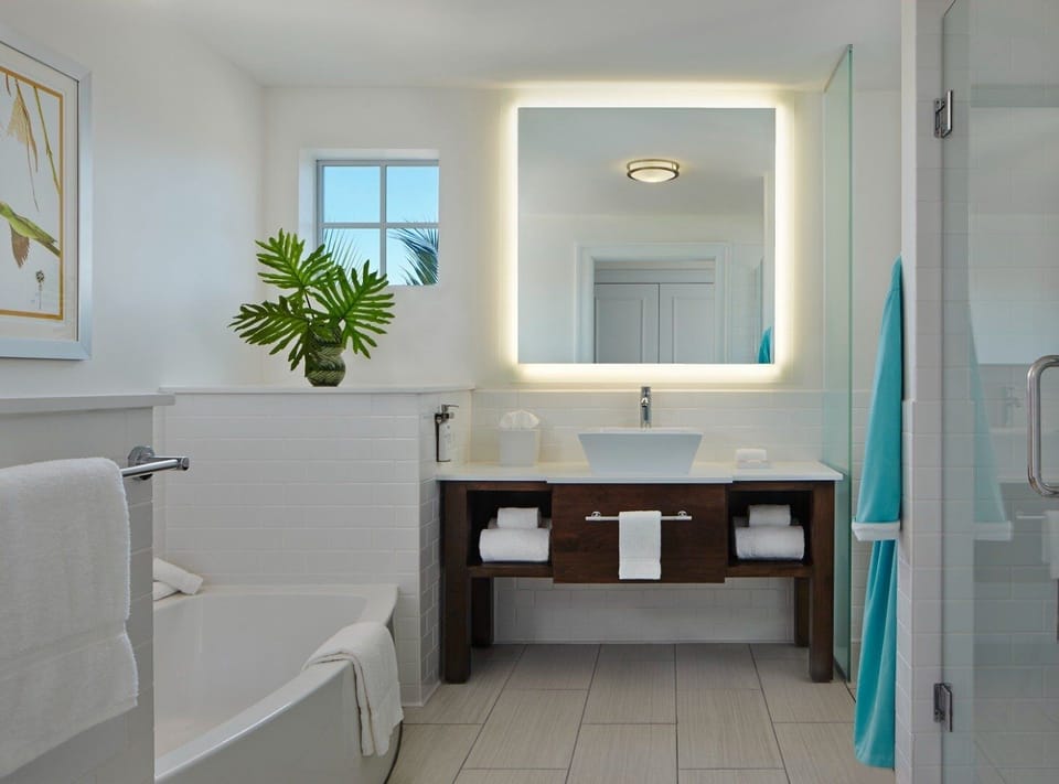 Unwind with fluffy towels and a softly lit vanity.