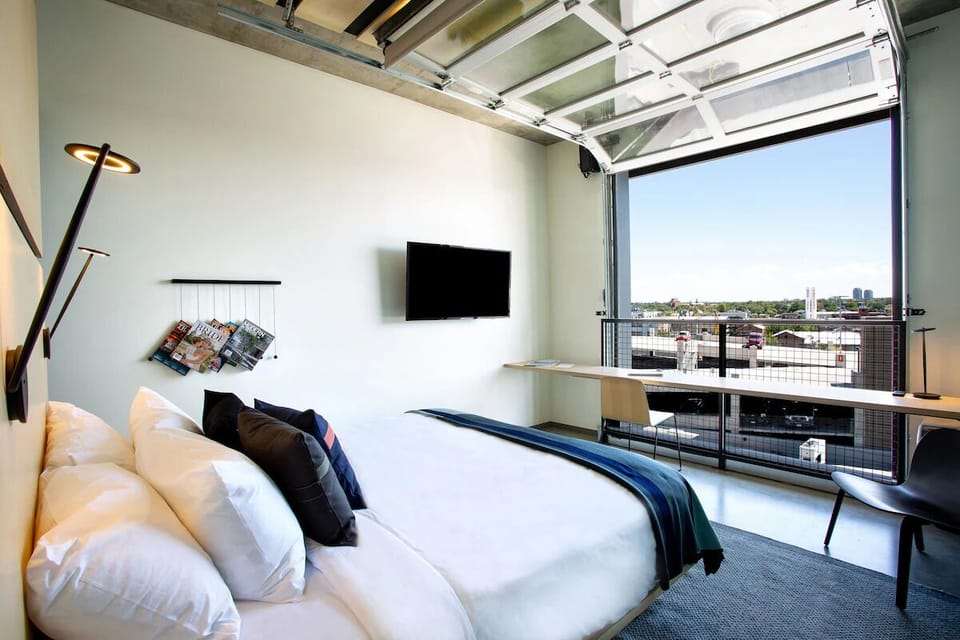 Wake up to skyline views in crisp, cloud-soft bedding.