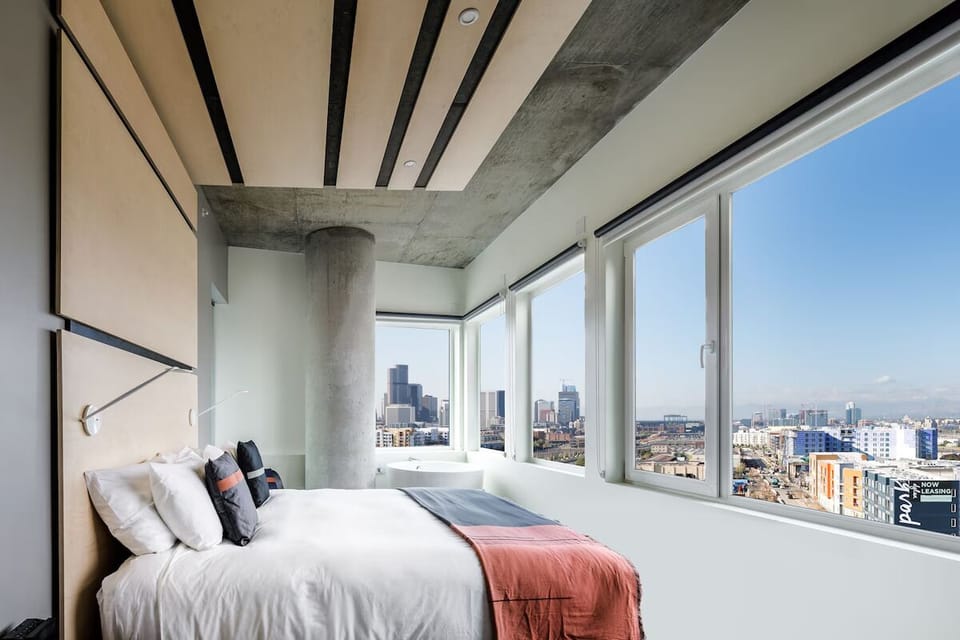 Wake up to sweeping city views beside a spa-like tub.