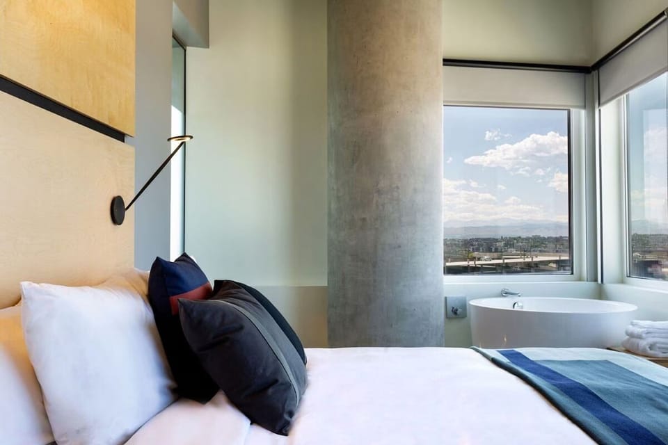Linger in serene comfort with bathtub views and plush pillows.