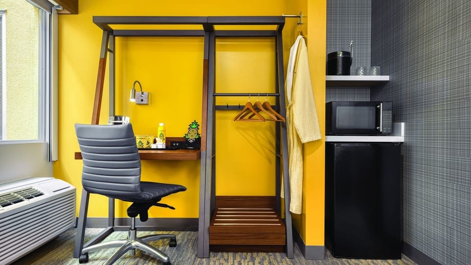 Settle in with a mini-fridge, microwave, and easy storage.