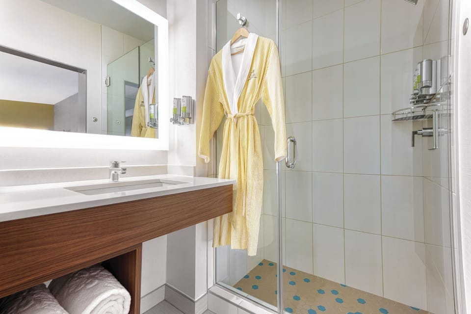 Indulge in a spa-like shower with plush robe waiting.