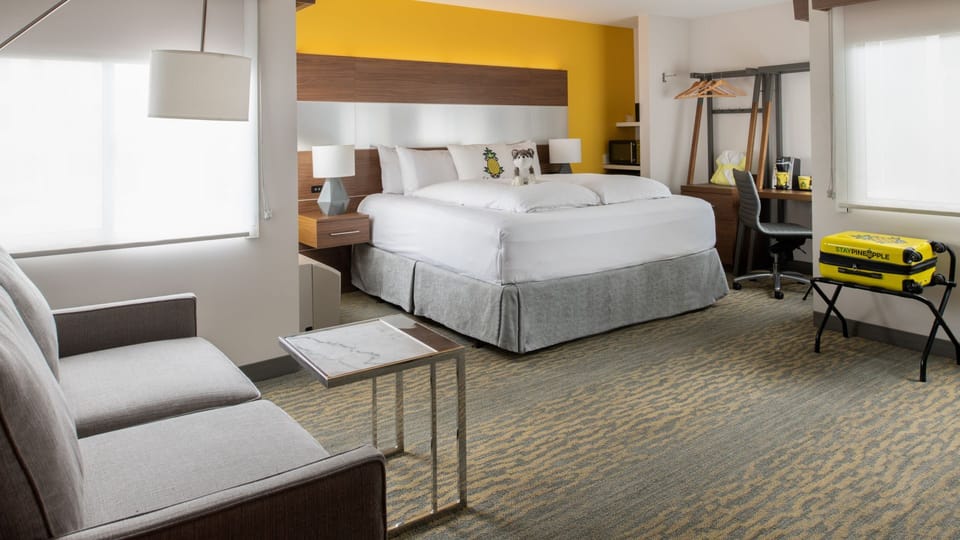 Unwind in a bright king room with cozy lounge seating.