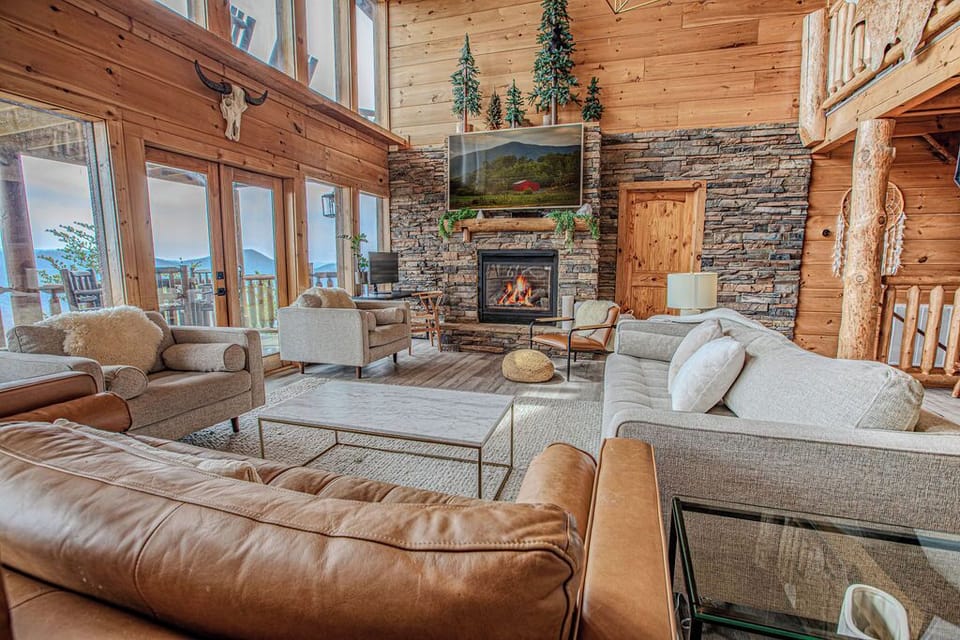 Cozy Yet Spacious Living Room Retreat – Gather around the stone fireplace and enjoy the warmth of this inviting living space. With soaring ceilings, oversized windows, and plush seating, this is the ideal spot for relaxation and connection.