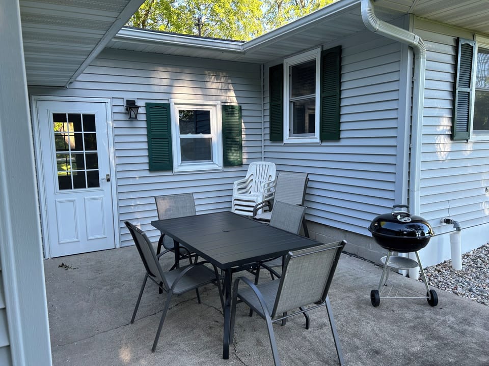 Charcoal grill with a patio table to eat and relax at
