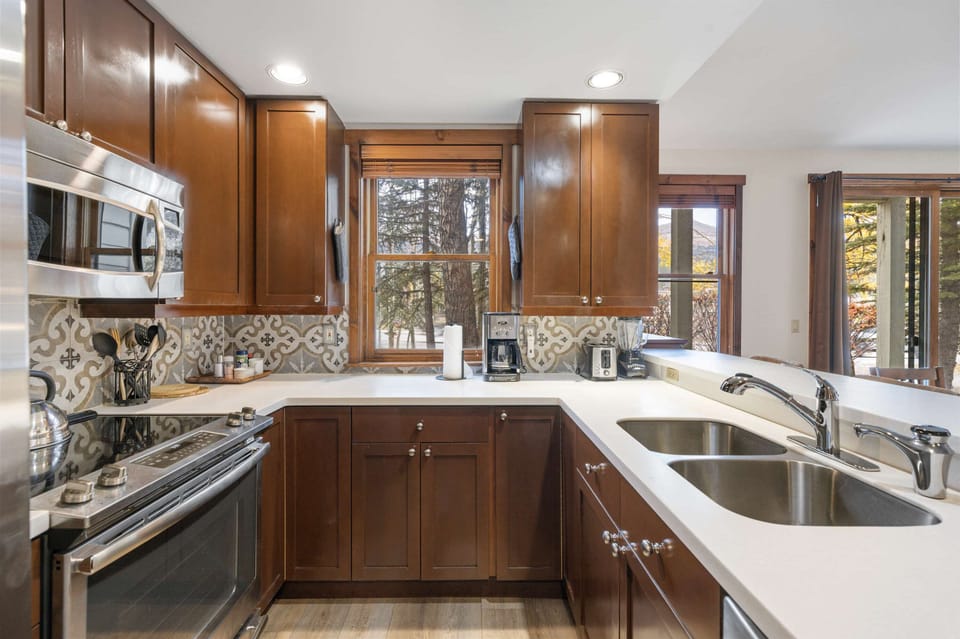Kitchen: Drip coffee maker, Crockpot, blender, waffle maker, toaster, cooking utensils, tableware