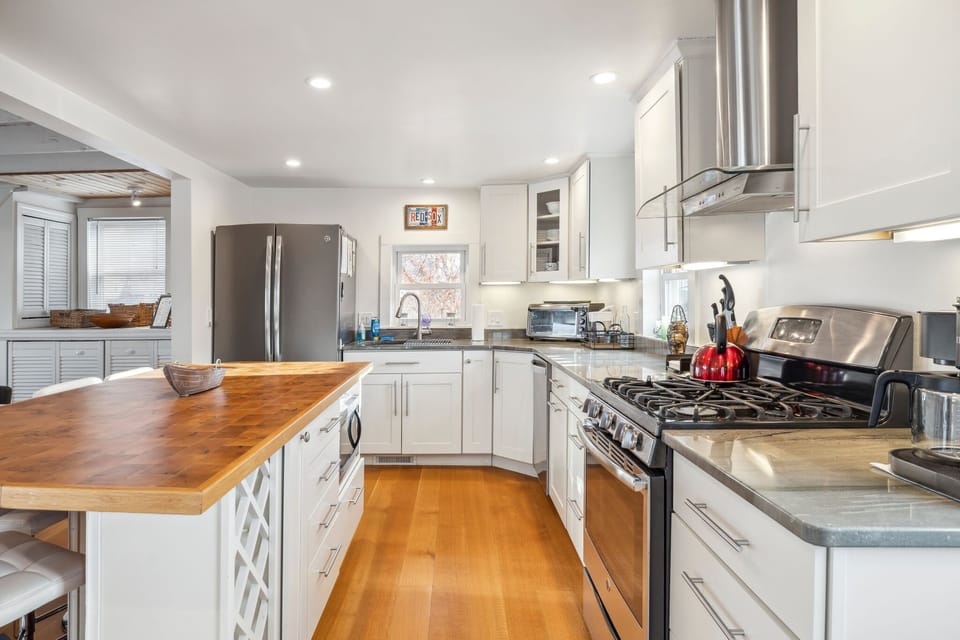 The fully equipped kitchen! This kitchen features a gas stove, seating for 4 at the island, a dishwasher and provided coffee! 