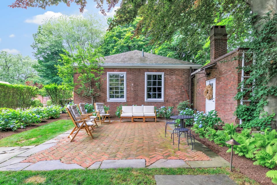 Enjoy peaceful mornings or relaxed afternoons in this charming brick courtyard, surrounded by lush landscaping and cozy seating. A perfect nook for coffee, conversation, or quiet reflection.
