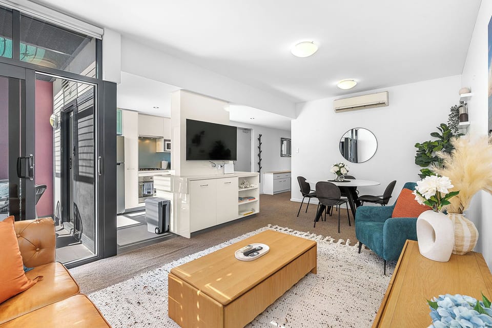 Relax in our bright living space, with comfy chairs and a glass doors open to your balcony getaway.