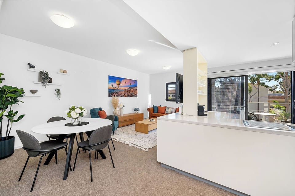Explore into a bright, open living space, where a modern dining area flows seamlessly into a comfortable lounge