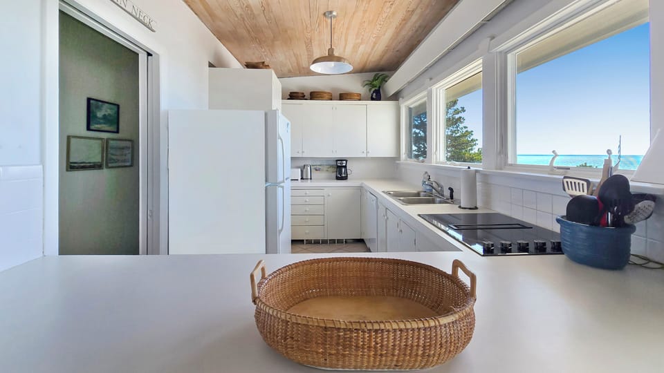 Nicely equipped kitchen has incredible views of the water too