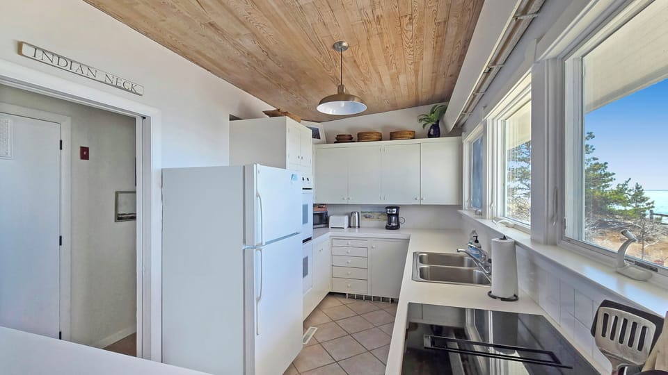 Nicely equipped kitchen has incredible views of the water too