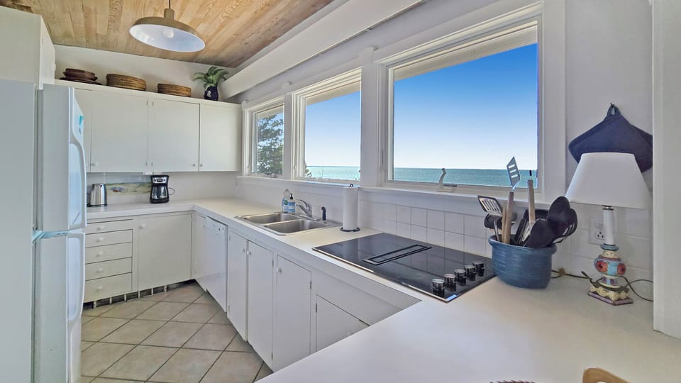 Nicely equipped kitchen has incredible views of the water too