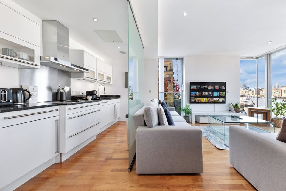 Glass divider between kitchen and living area giving you segregation. 