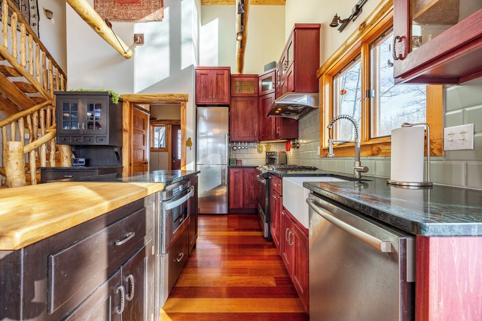 Fully equipped kitchen with modern appliances and handcrafted wood details — cook up meals with a view!