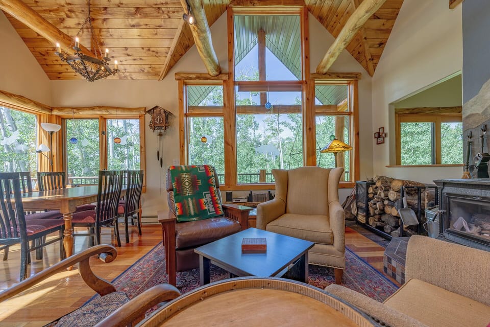 Soaring wood-beam ceilings and panoramic windows bring the mountain views inside. Cozy up by the fire with plenty of space for the whole group.