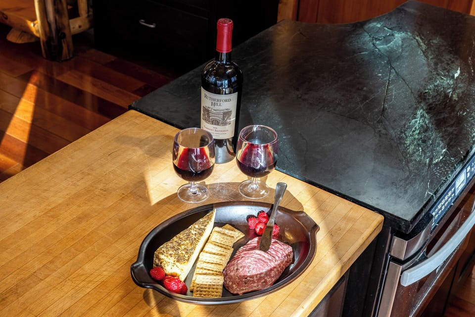 Unwind with wine and snacks on our farmhouse-style butcher block — kitchen comforts meet mountain charm.