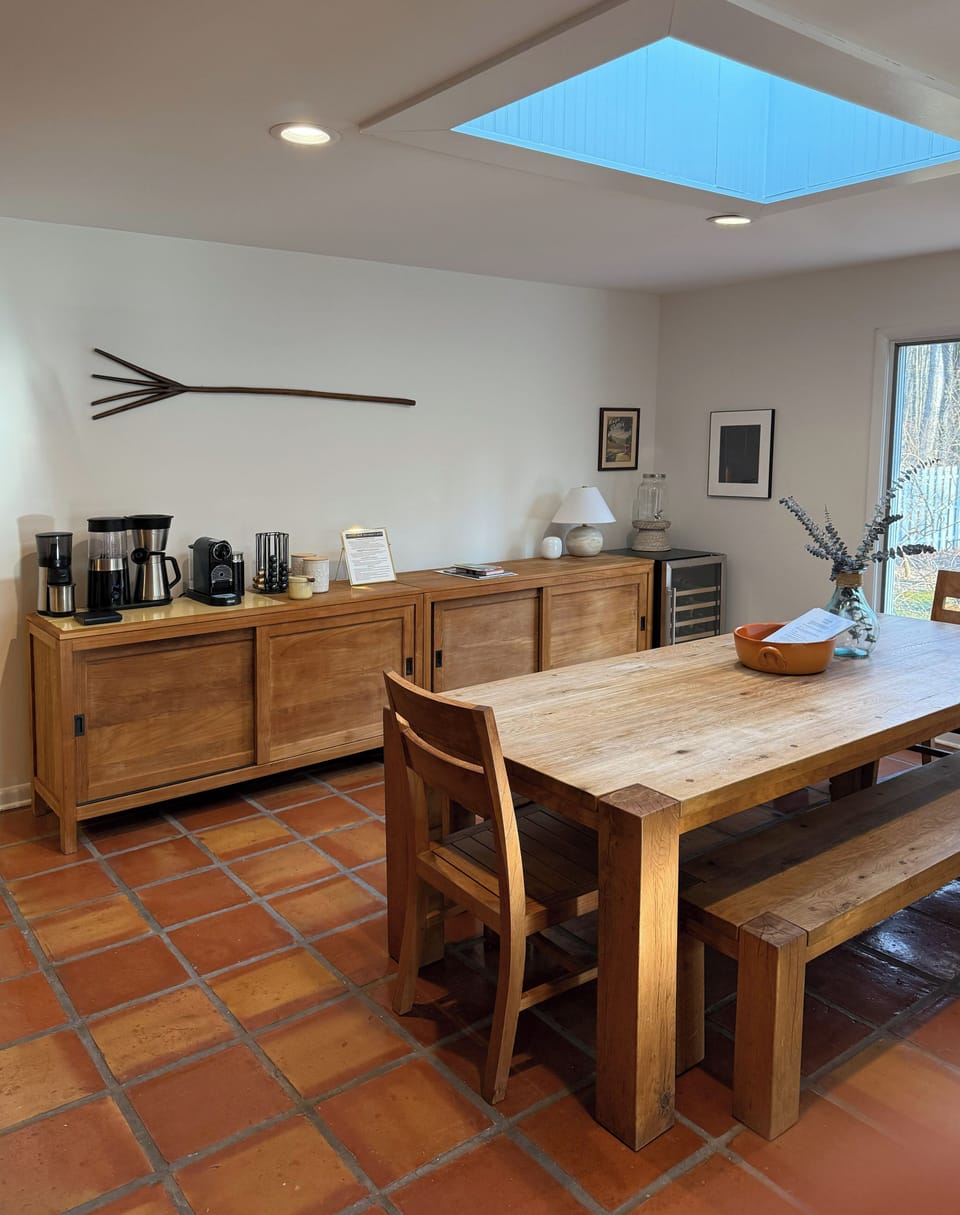 Big farm table seats 8 comfortably and coffee bar and wine fridge 