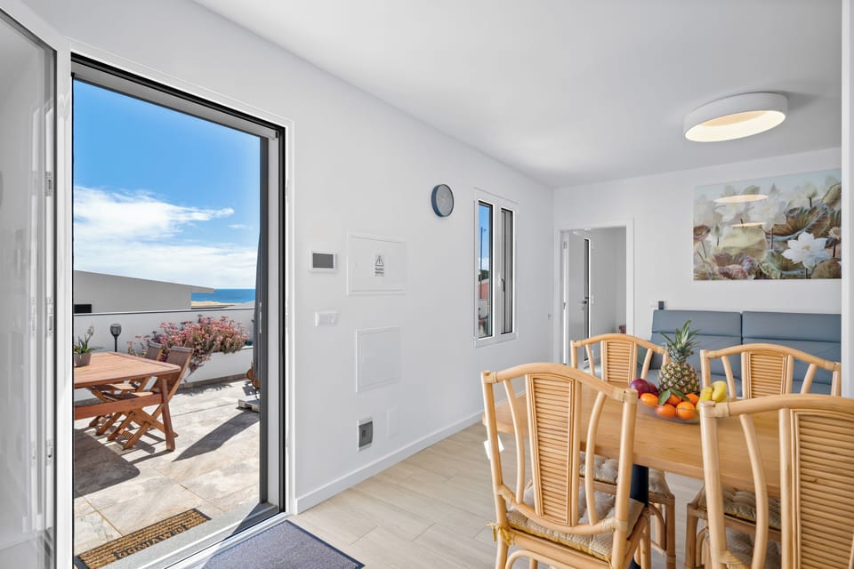 fully equipped kitchen, a comfortable living area, and a dining table