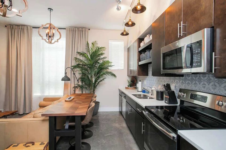 Full kitchen with range, microwave and breakfast bar seating