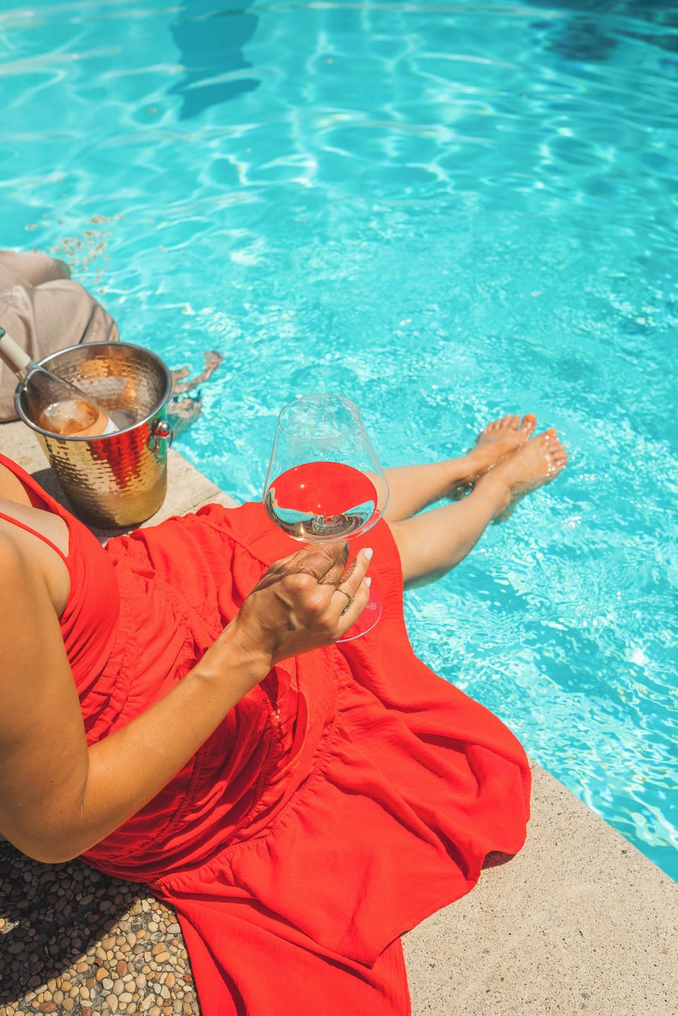 Linger poolside with a glass of local wine and your feet in the water.