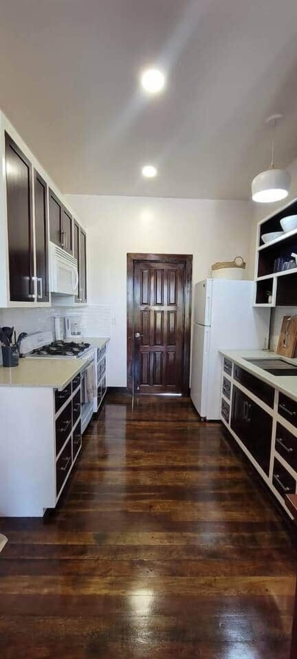 A spacious kitchen featuring ample counter space and modern appliances, fully stocked with cookware, utensils, and basic essentials—perfect for preparing and enjoying home-cooked meals in comfort.