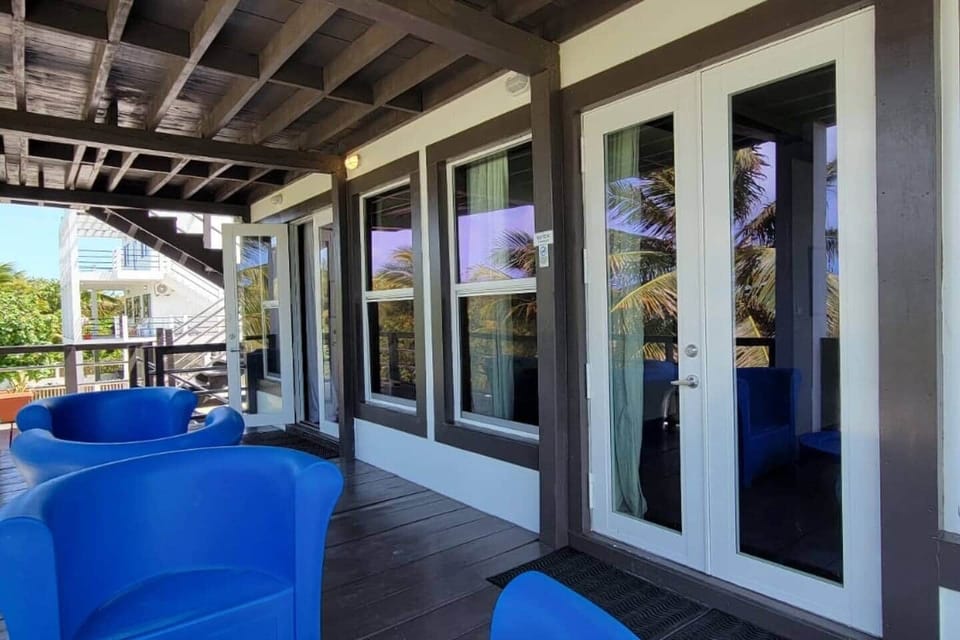 Large decks overlooking the backyard, furnished with comfortable chairs—ideal for relaxing while enjoying the cool breeze and beautiful views.