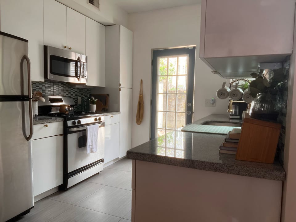 Bright, modern kitchen stocked with essentials, cookbooks, and cozy touches.