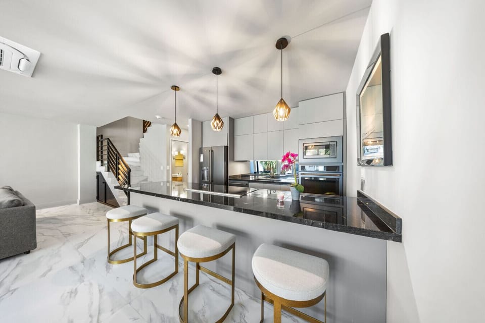 A stylish open kitchen with a spacious island and cozy bar seating—great for easy meals, coffee breaks, or casual chats.