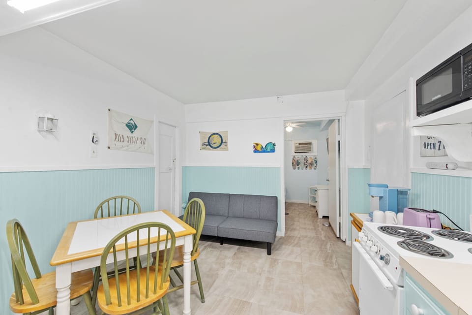 Kitchen, dining and living room - Cozy kitchen, dining and living room area with a futon for extra bedding