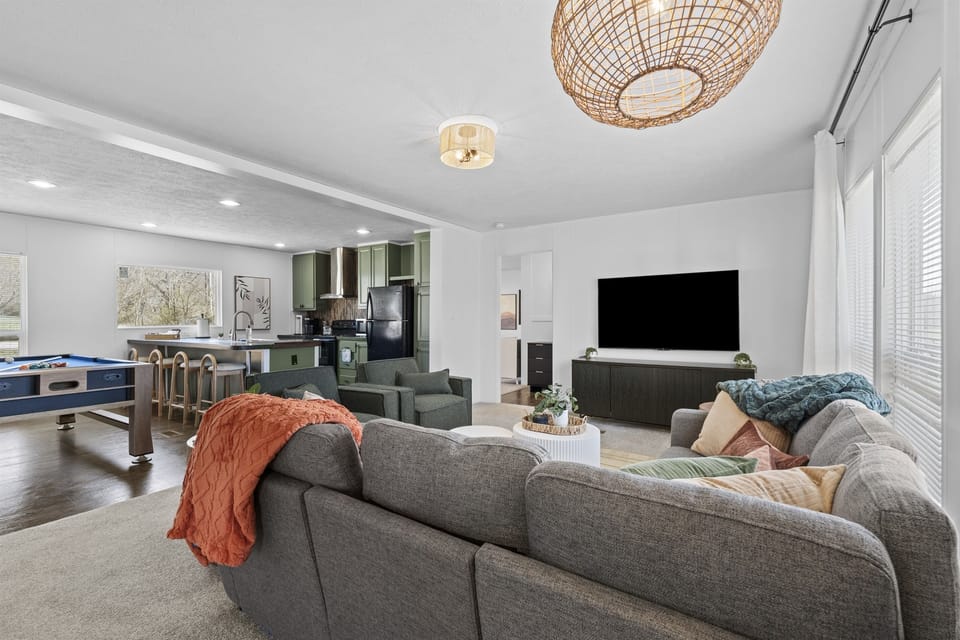 Hang out in the spacious living area, where comfortable seating, a large TV, and an open layout create the perfect spot for unwinding and enjoying time together.