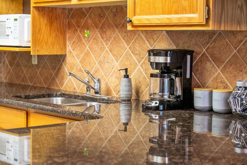 Full kitchen, on the main floor, with a blender, drip coffee maker, ground coffee, tea & sugar.