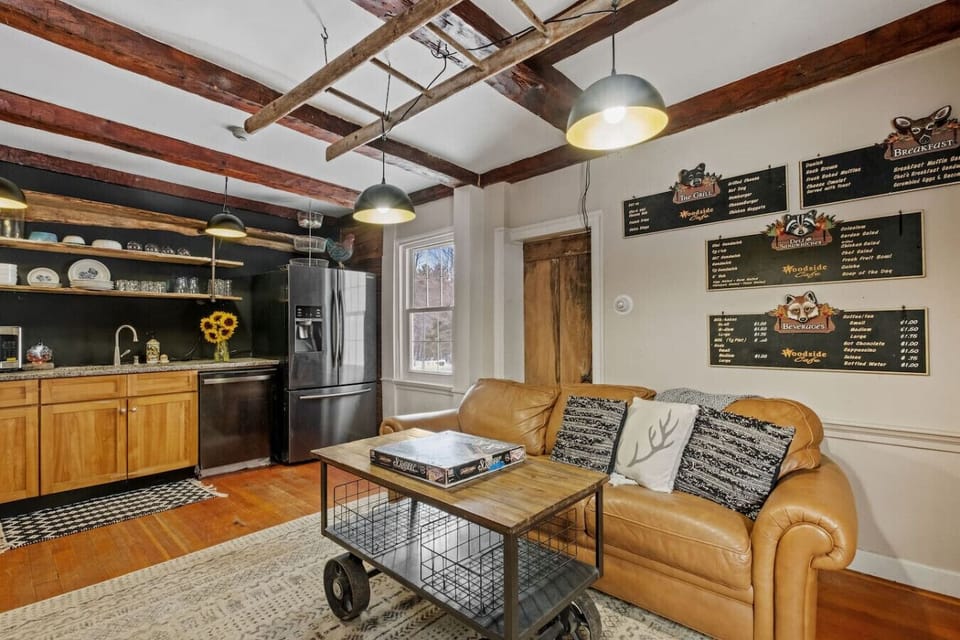 Fully equipped kitchen under warm wooden beams.