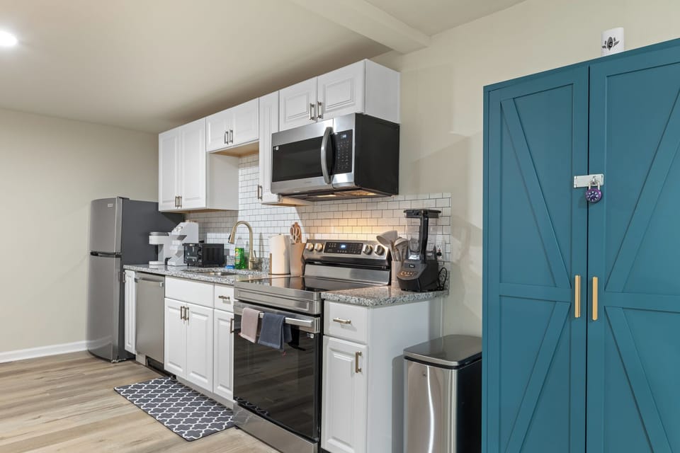 Kitchen with all cooking essentials including blender, microwave and toaster. 