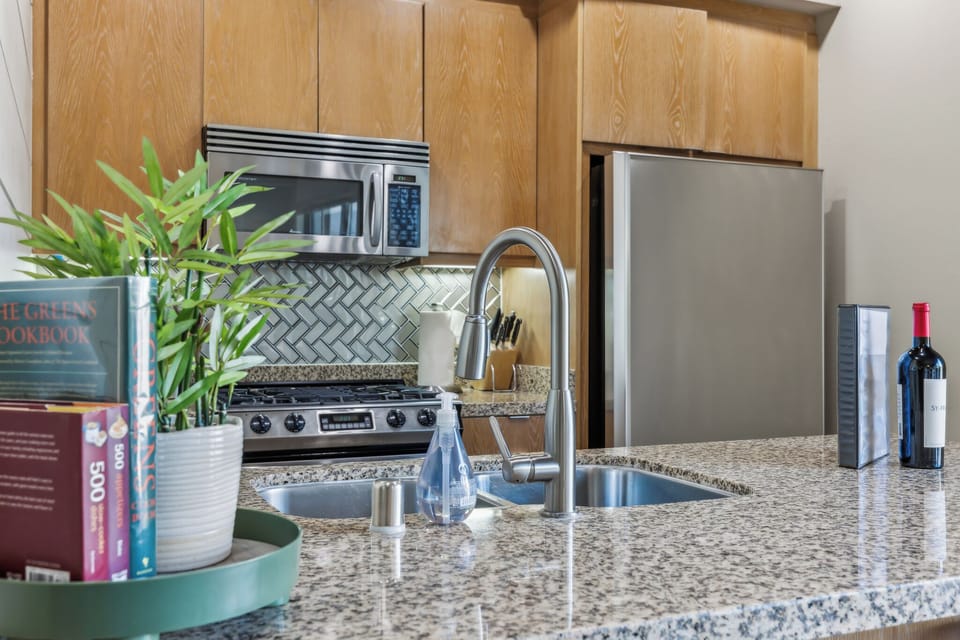 Welcome to our airy kitchen! With modern appliances, stylish countertop, and a charming dining nook, it’s perfect for cooking and socializing. This inviting space is ready for your culinary adventures and unforgettable meals!