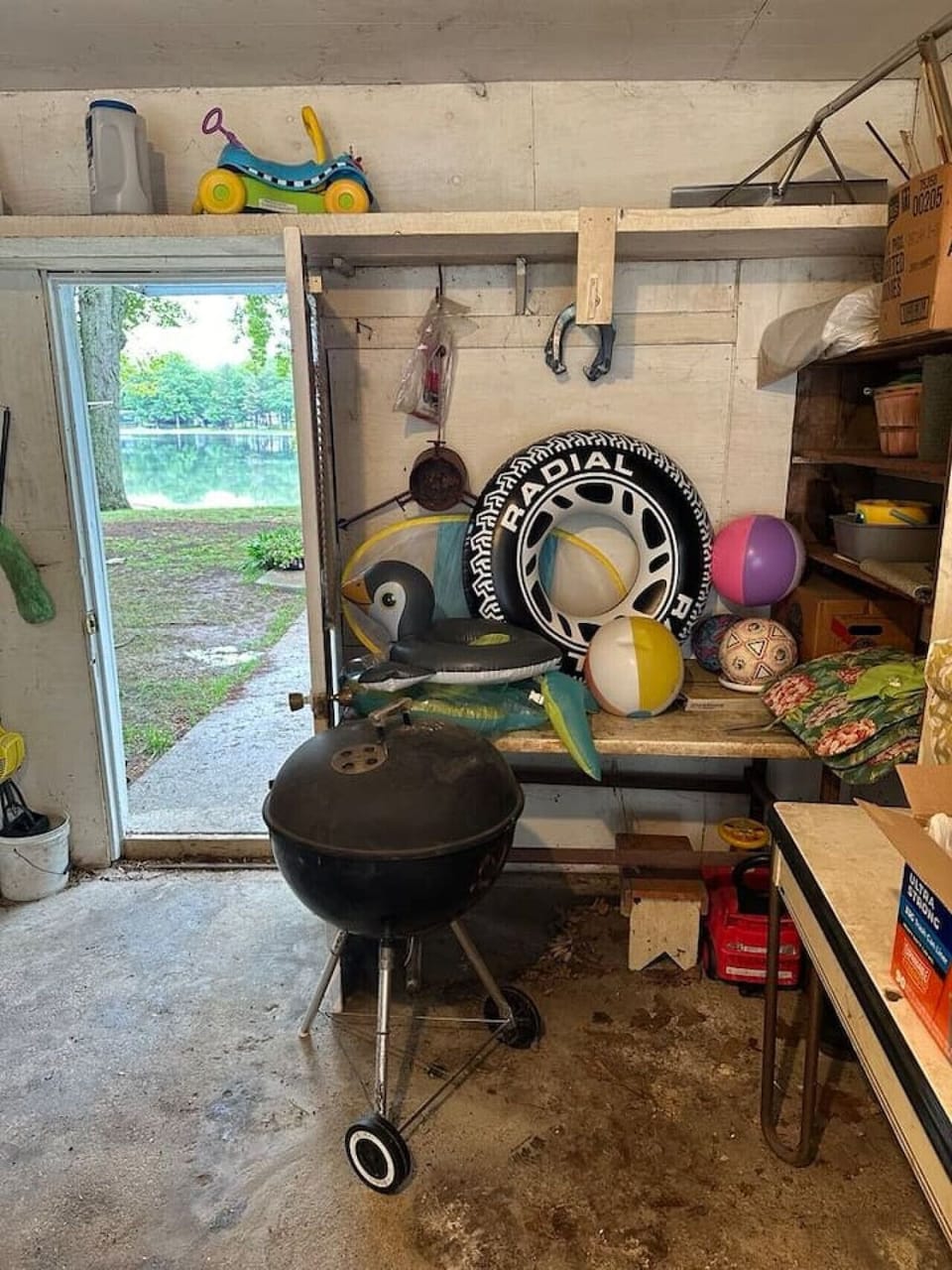 Beach toys and charcoal grill in the garage. Gas grill on back patio.