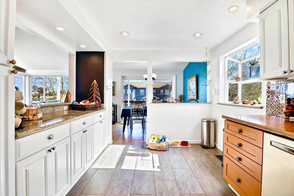 Sunny, pet-friendly kitchen with open flow to dining and sunroom